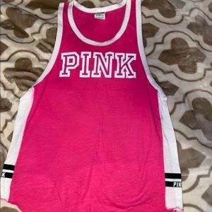 Pink and white tank top with pink logo on front.